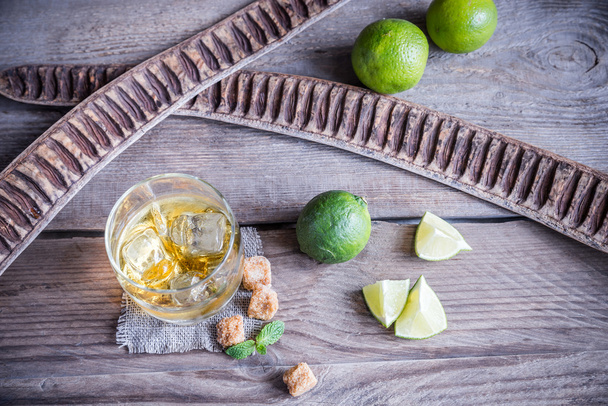 Glass of rum on the wooden background - Foto, Imagen