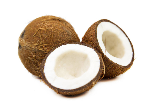 Two coconut one of which split isolated on white background. Clipping path. - Valokuva, kuva