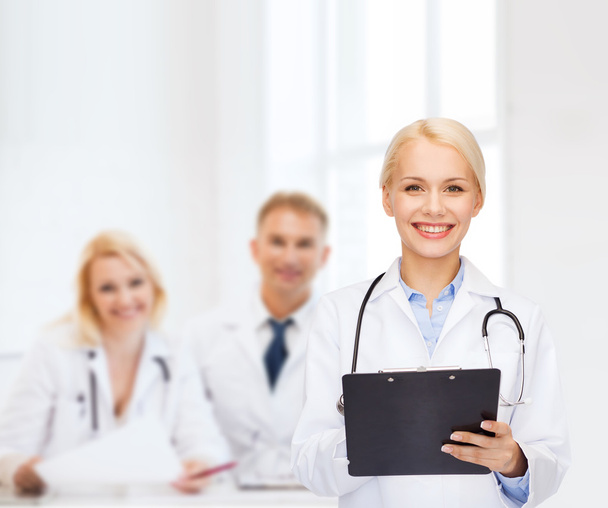 smiling female doctor with clipboard - Photo, image