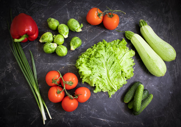Fresh different vegetables on dark background - Foto, imagen