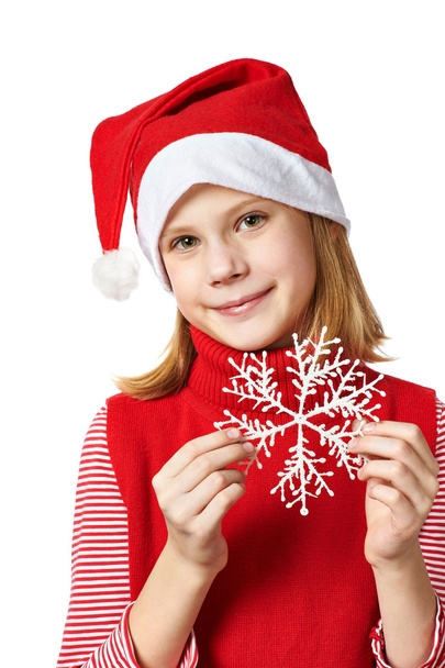 Beautyful girl in red Santa hat with snowflake - Foto, imagen