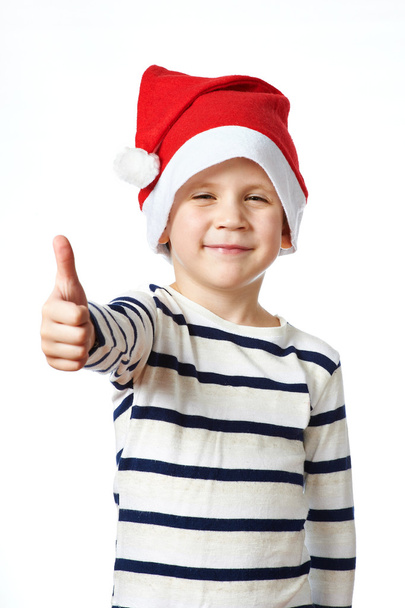 Little Boy in Santa hat with thumbs up sign ok isolated - Foto, Bild