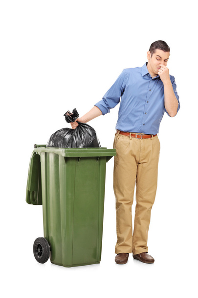 Man throwing out bag of trash - Foto, afbeelding