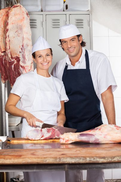 Confident Butchers At Counter In Shop - Foto, Imagen