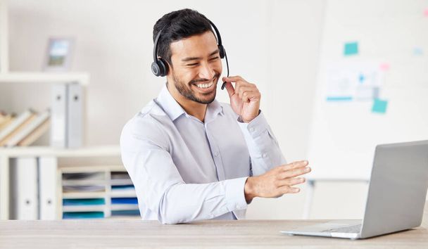 Happy businessman working in a call center. Customer service rep helping on a call. Sales agent speaking to client. IT assistant helping a customer. Telemarketing agent using headset to talk to client - Φωτογραφία, εικόνα
