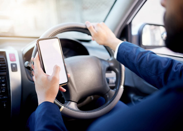 Closeup shot of an unrecognisable businessman using a cellphone while driving a car. - Fotografie, Obrázek