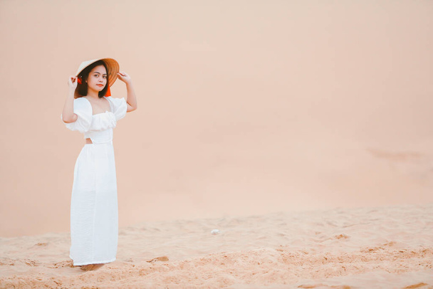 Portraits of  woman with white dress walking on a bright summer day, in the Mui Ne desert Vietnam holliday vacation concept. - Fotoğraf, Görsel