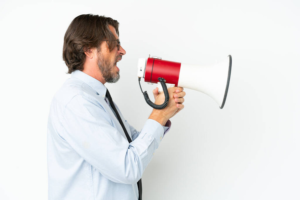 Senior dutch business man isolated on white background shouting through a megaphone - Fotó, kép