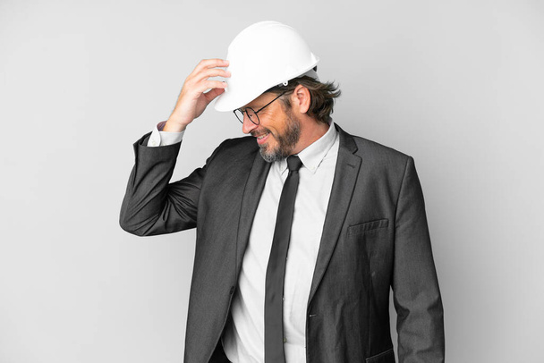 Young architect man with helmet over isolated background laughing - Photo, Image