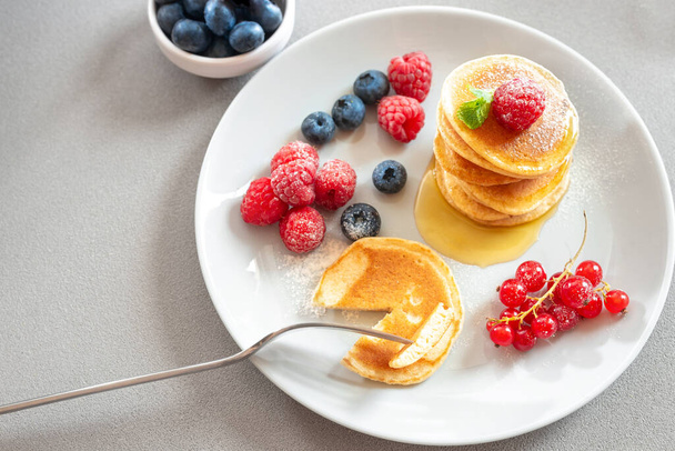 Family eating pancakes for breakfast. Food for breakfast healthy eating. Homemade pancakes on a white background. European breakfast pancakes and berries. Pancakes without butter with berries. Food - Foto, Imagem