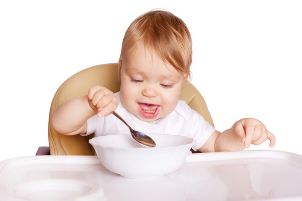 Дитина їсть з ложкою. Ізольовані на білому
 - Фото, зображення