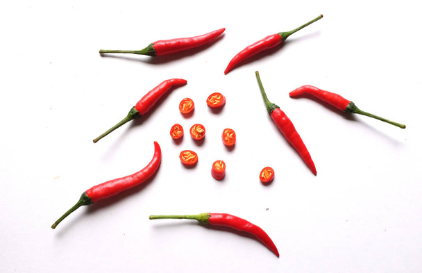 Ripe red hot chili peppers cut into pieces vegetable isolated on white background.cooking ingredients - Foto, Imagem