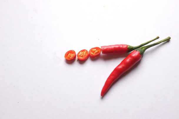 Ripe red hot chili peppers cut into pieces vegetable isolated on white background.cooking ingredients - Foto, Imagem