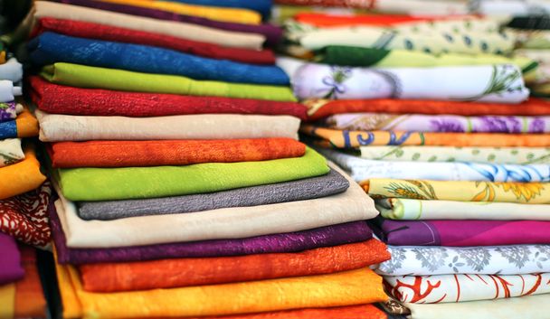 lots of colored cloth tablecloths for sale in the town market - Photo, Image