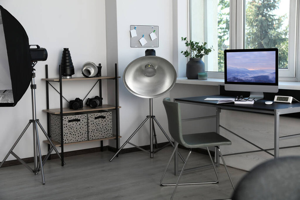 Professional lighting equipment and comfortable workplace in photo studio. Interior design - Photo, Image