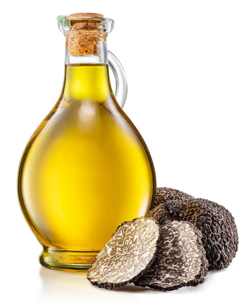 Truffle oil and black edible winter truffle on white background. - Фото, изображение