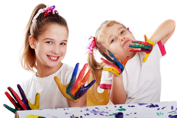 Portrait of two cheerful girls show their hands painted in bright colors - Foto, immagini