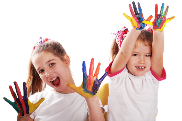 Portrait of two cheerful girls show their hands painted in bright colors - Foto, afbeelding