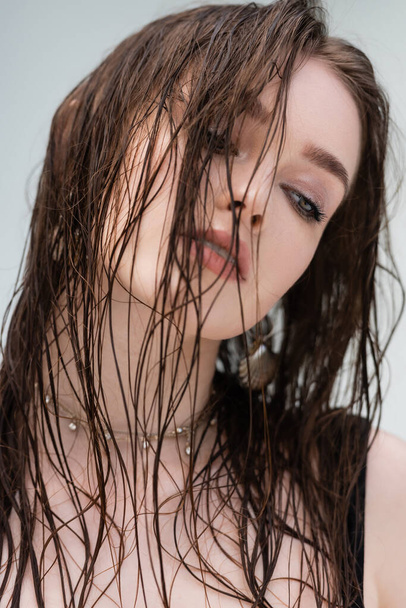 Portrait of brunette woman with wet hair looking away outdoors  - Fotografie, Obrázek