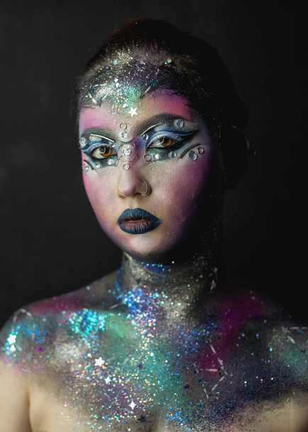 Portrait of young female model with creative makeup,  rhinestones and piercing - Foto, Imagen