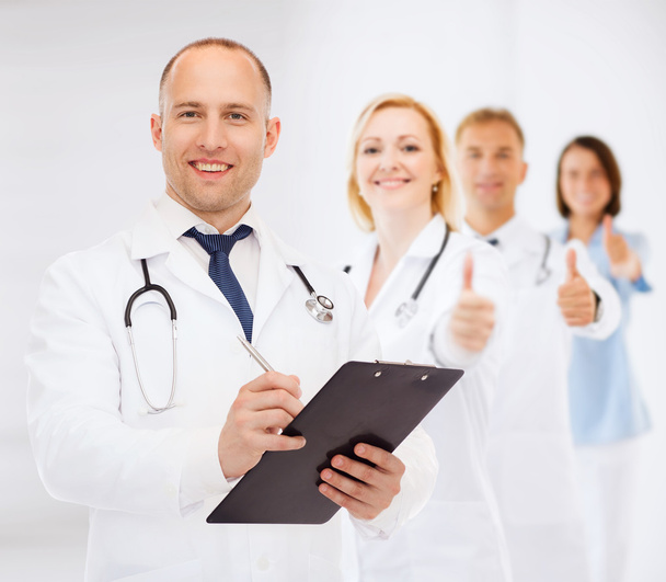 smiling male doctor with clipboard and stethoscope - Foto, Bild