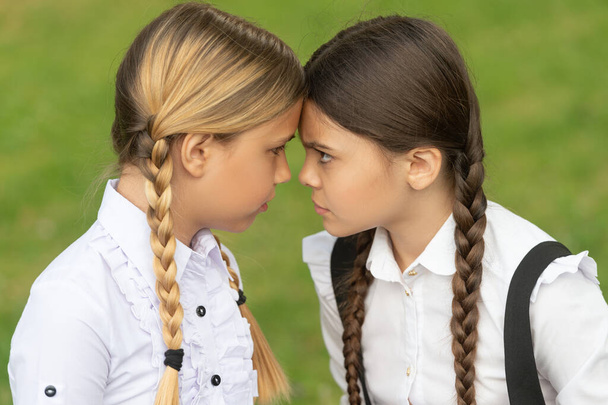 confrontation of two teen school girls. school conflict. opposition of school girls. - Fotó, kép