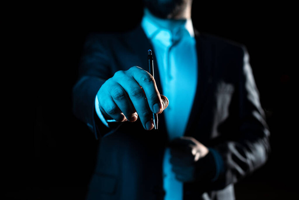 Businessman Pointing Important Informations With Pen In Hand. - Foto, immagini