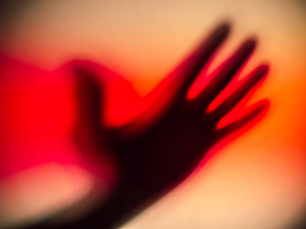 A bloody shadow of a silhouetted hand. - Zdjęcie, obraz