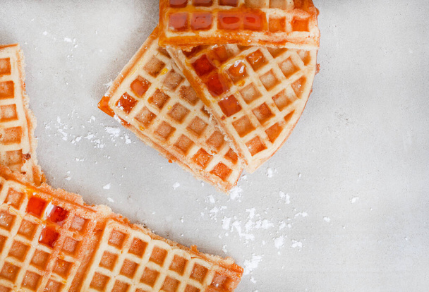 Waffles with syrup on light grey mottled surface with copy space - Фото, изображение