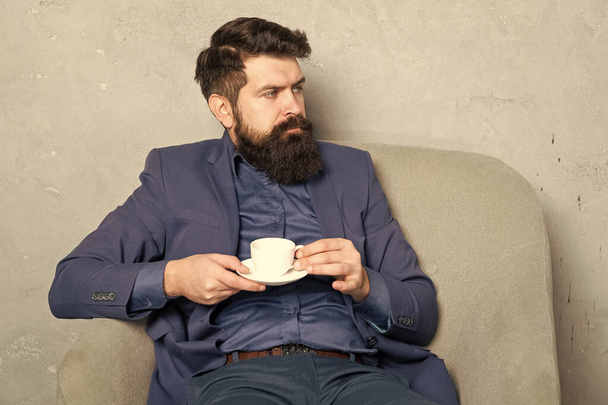 Relaxing professional man drink coffee sitting in rest armchair, coffee break. - Valokuva, kuva