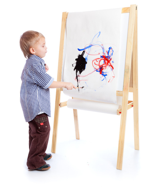 A boy is drawing on a blackboard. Isolated on a white background - Valokuva, kuva