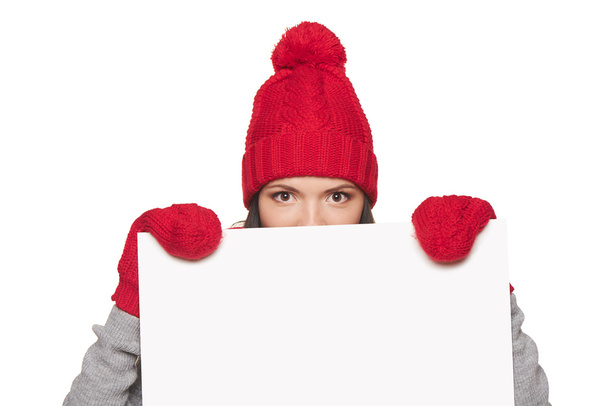 Winter woman peeking out of whiteboard - Фото, изображение
