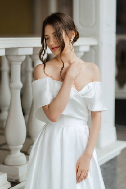 portrait of a young bride girl in a short white dress on a rainy day - Photo, image