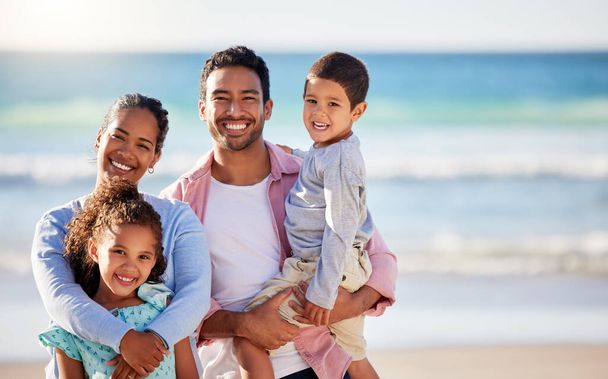 This family is all for beach days. a young couple and their two children spending the day together at the beach - Photo, Image