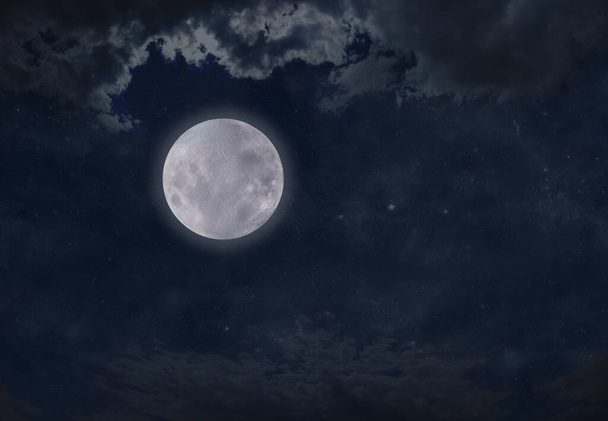 High Full Moon Night Time Cloudscape - dark blue night sky with a bright full moon off centre and clouds above with plenty of copy space for messages  - Zdjęcie, obraz