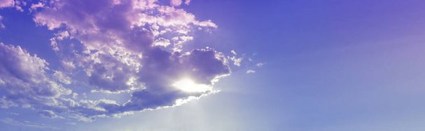 Panoramic Evening Sunset Banner Background - romantic vivid blue and pink lilac sky with sun peeking through cloud and copy space on right side - Fotó, kép