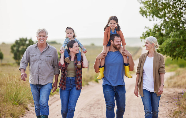 a multi-generational family walking together on a farm. - Φωτογραφία, εικόνα
