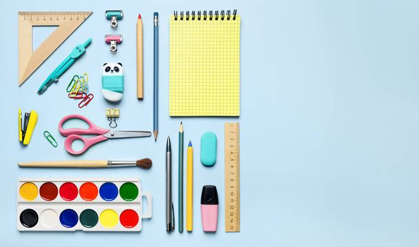 Colorful stationary school supplies on blue background, space for text flat lay. Back to school template - Φωτογραφία, εικόνα