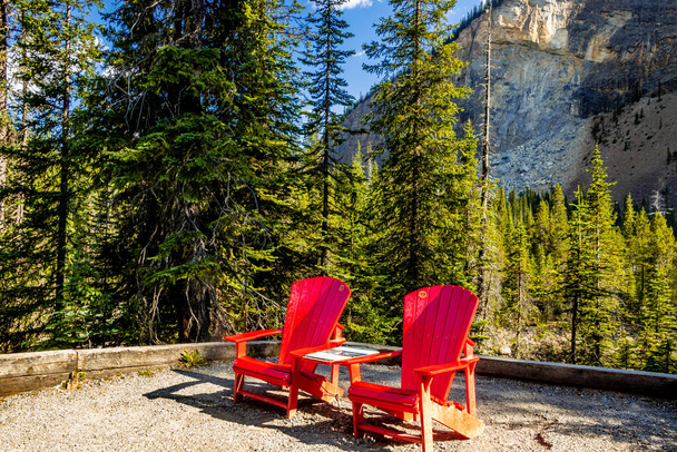 Red Chairs take in the scene Takakkawa Falls Yoho National Park British Columbia Canada - Photo, image