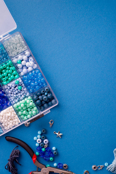 Set van kleurrijke kralen en accessoires voor het maken van sieraden armbanden van kralen en kettingen. DIY bijouterie concept. Flat Lay achtergrond met kopieerruimte. - Foto, afbeelding