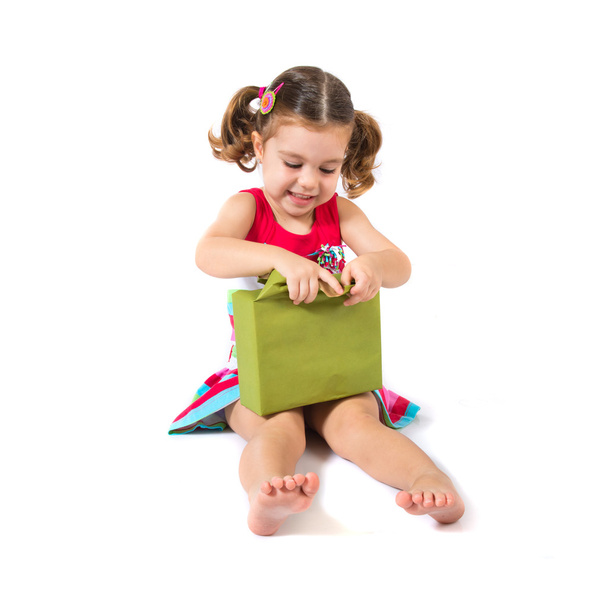 Kid holding a present over white background - Foto, Imagen