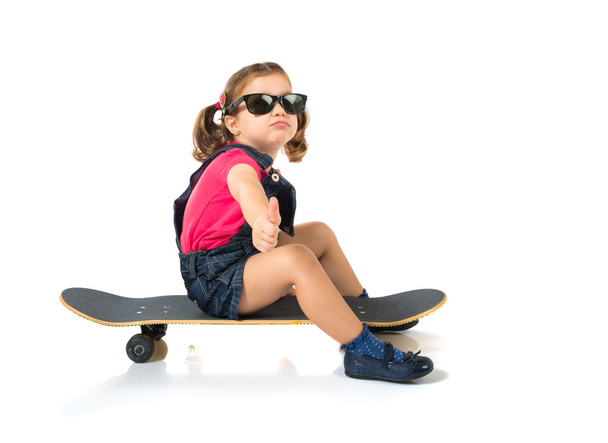 Blonde kid with skate over white background - Photo, Image