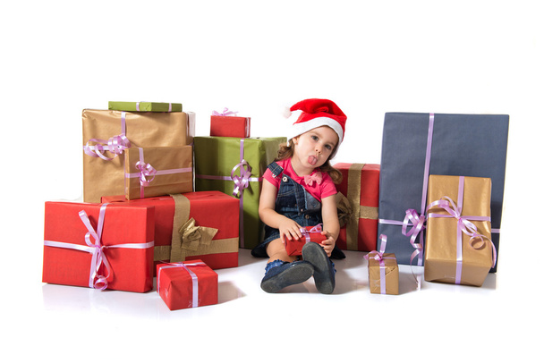 Blonde christmas kid around several presents - Фото, изображение