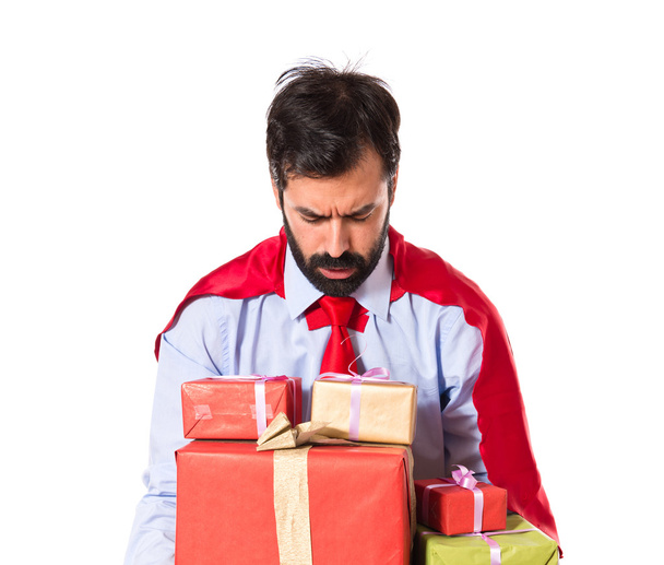 Businessman dressed like superhero holding gifts - Fotó, kép