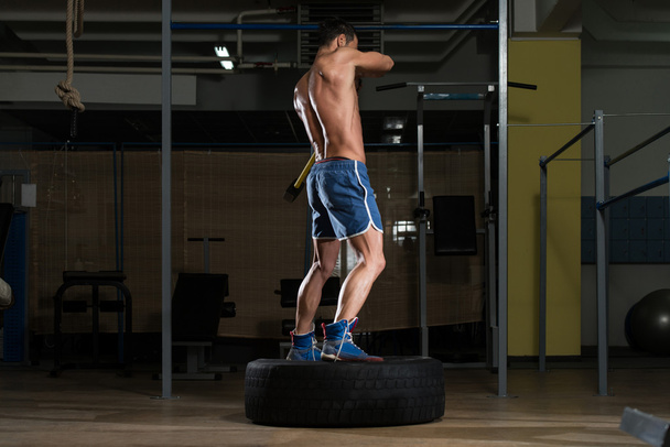 Workout At Gym With Hammer And Tractor Tire - Fotoğraf, Görsel