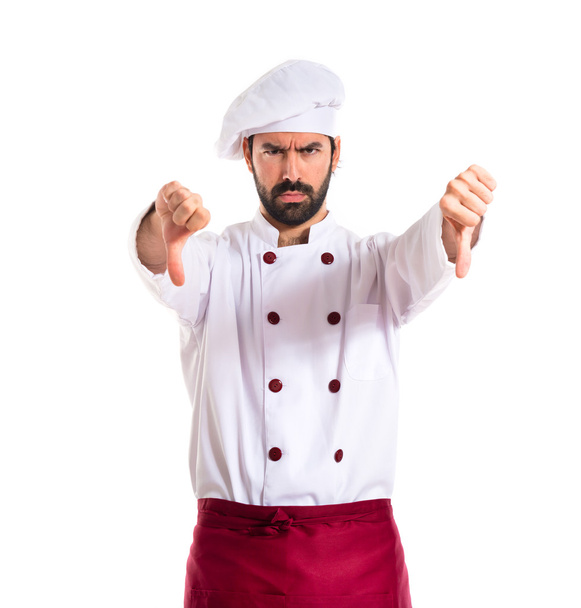 Chef doing a bad signal over white background - Fotoğraf, Görsel