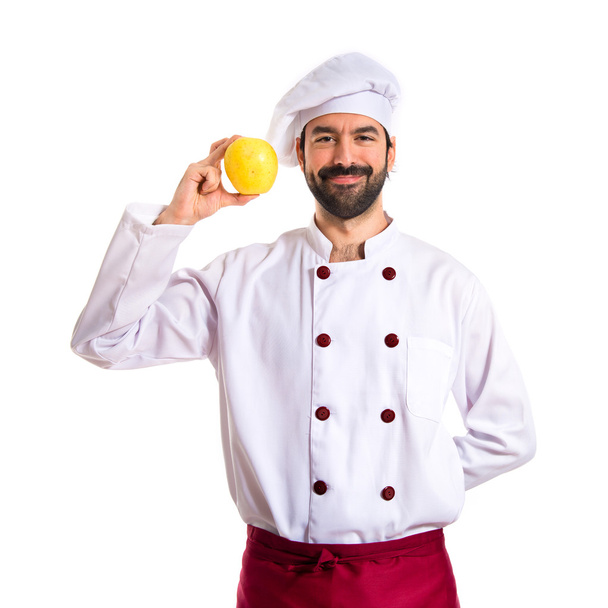 Chef holding an apple - Zdjęcie, obraz