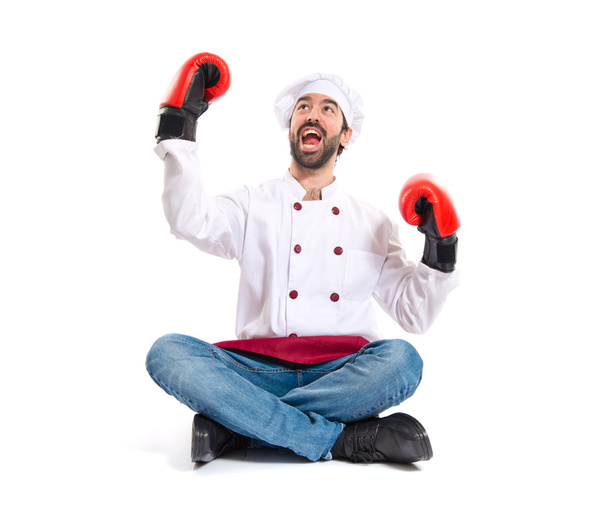 Chef with boxing gloves sitting on the floor - Fotoğraf, Görsel