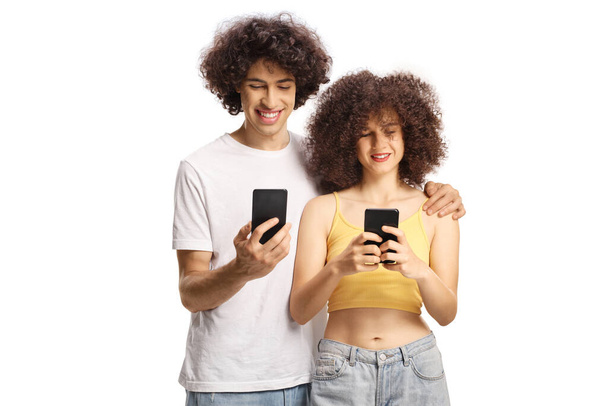 Guy and girl with curly hair using smartphones isolated on white background - Fotoğraf, Görsel