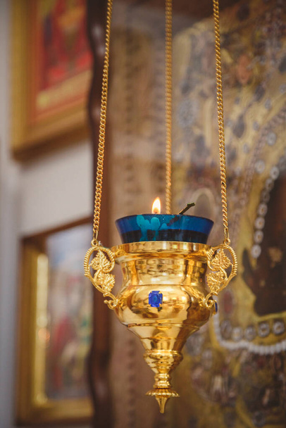 Burning blue and gold icon-lamp, candle in church on a icon background. Details in the orthodox christian church. - Φωτογραφία, εικόνα